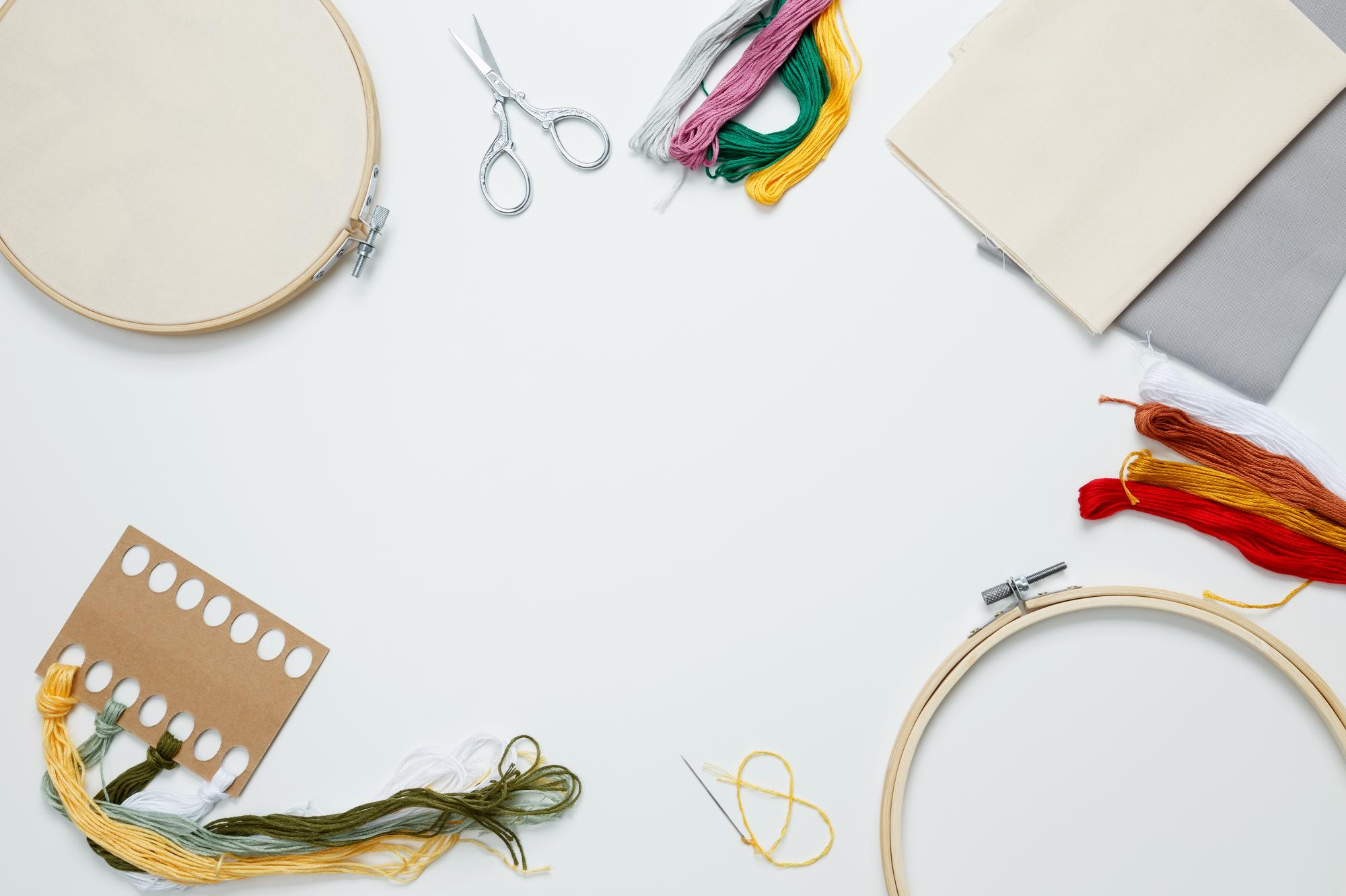 wide workshop table with hoops and threads